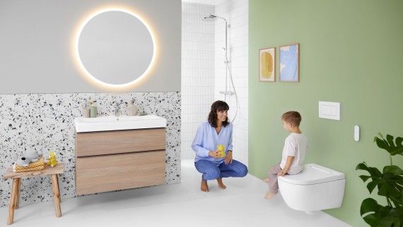 Woman and child in a bathroom with a Geberit AquaClean Alba shower toilet Woman and child in a bathroom with a Geberit AquaClean Alba shower toilet