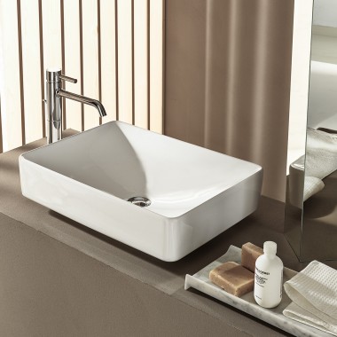 Lay-on washbasin with deck-mounted tap