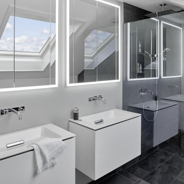 Bathroom under the roof with two washbasins and mirrors