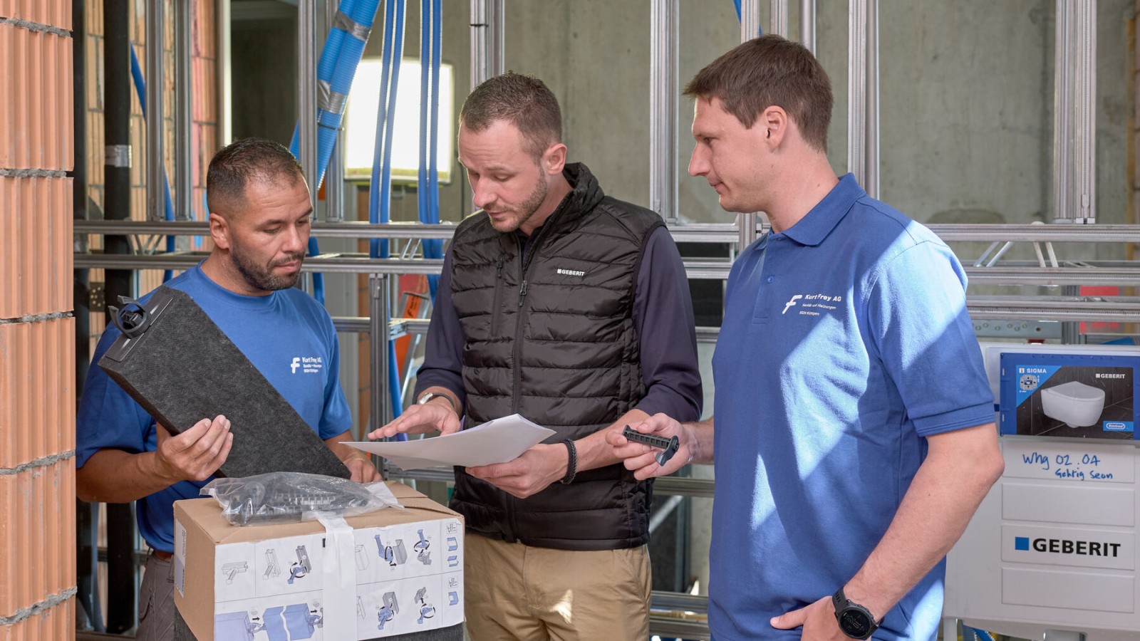 A Geberit sales representative advises plumbers on the construction site A Geberit sales representative advises plumbers on the construction site