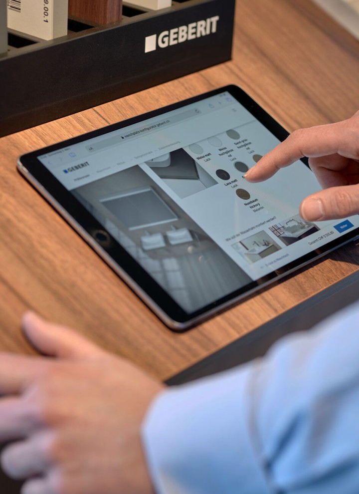 Man with tablet selects products in a configurator