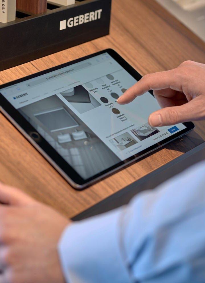 Man with tablet selects products in a configurator